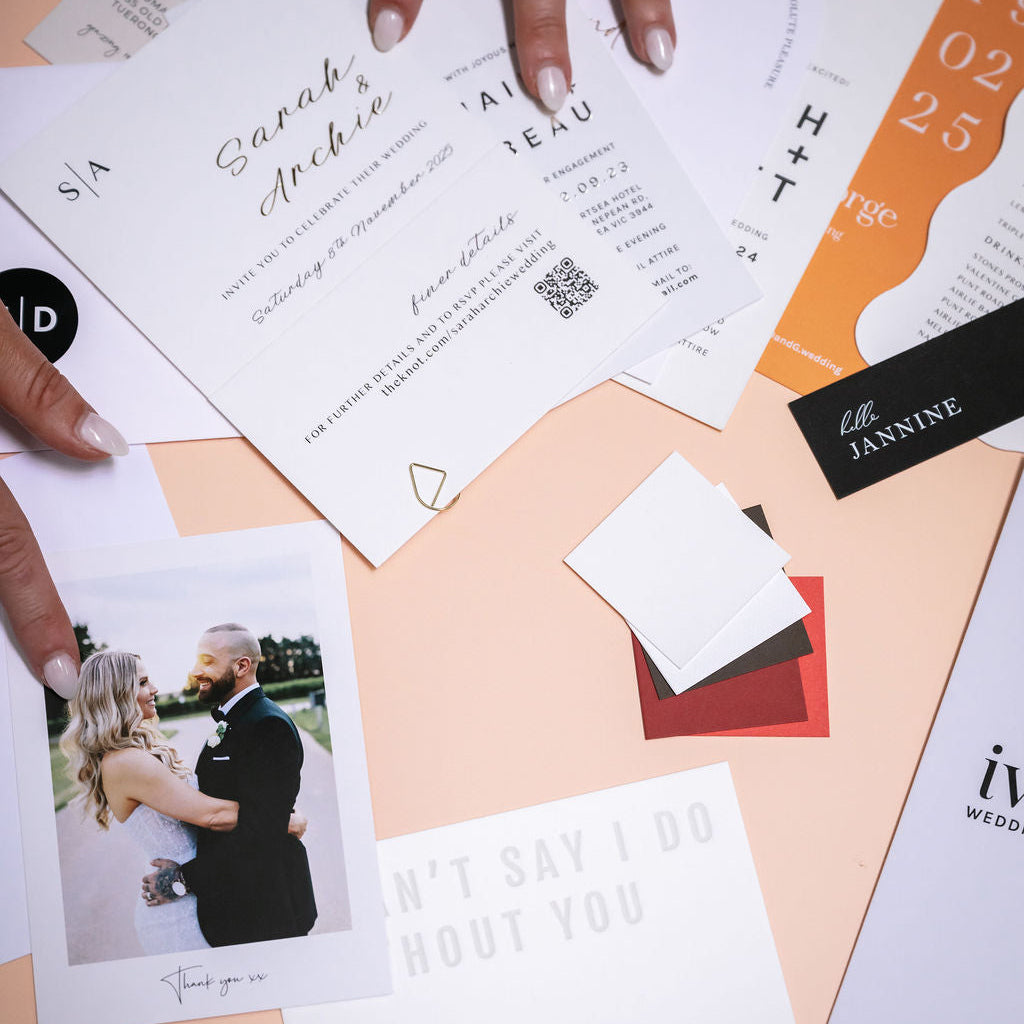 Stack of wedding stationery and invitation samples by Ivory & Ink Weddings