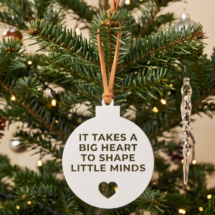 A white round Christmas ornament with the text &