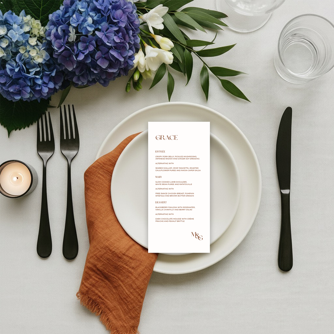 Burnt orange wedding menu with couples initials