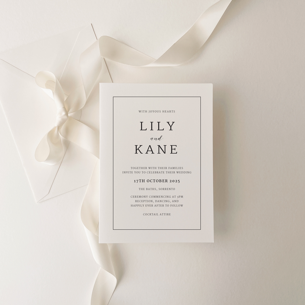 Lily wedding invitation suite by Ivory & Ink Weddings — refined and framed to perfection, with crisp lettering within a delicate border.